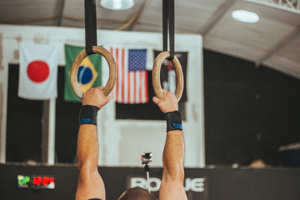 athelete hanging from the rings