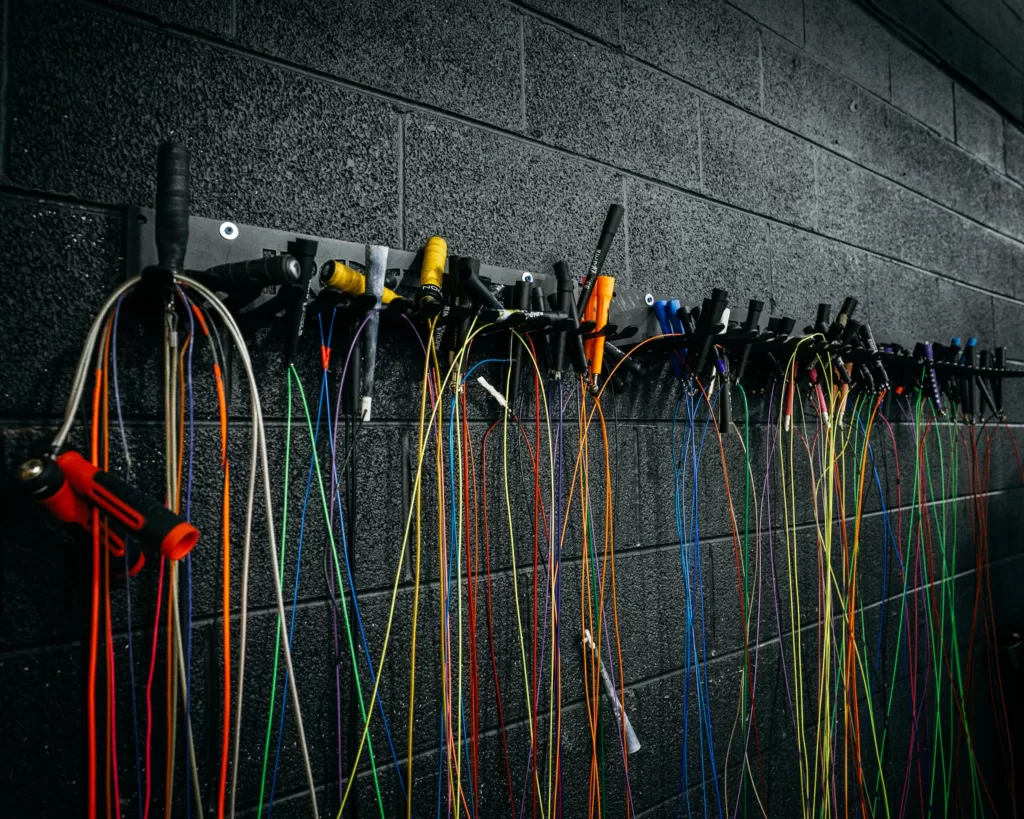 selection of jump ropes in a crossfit gym
