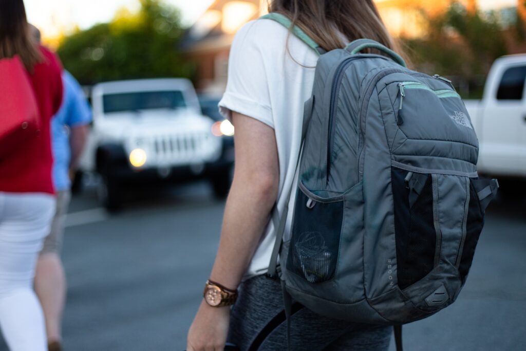 woman carrying a backpack to the gym