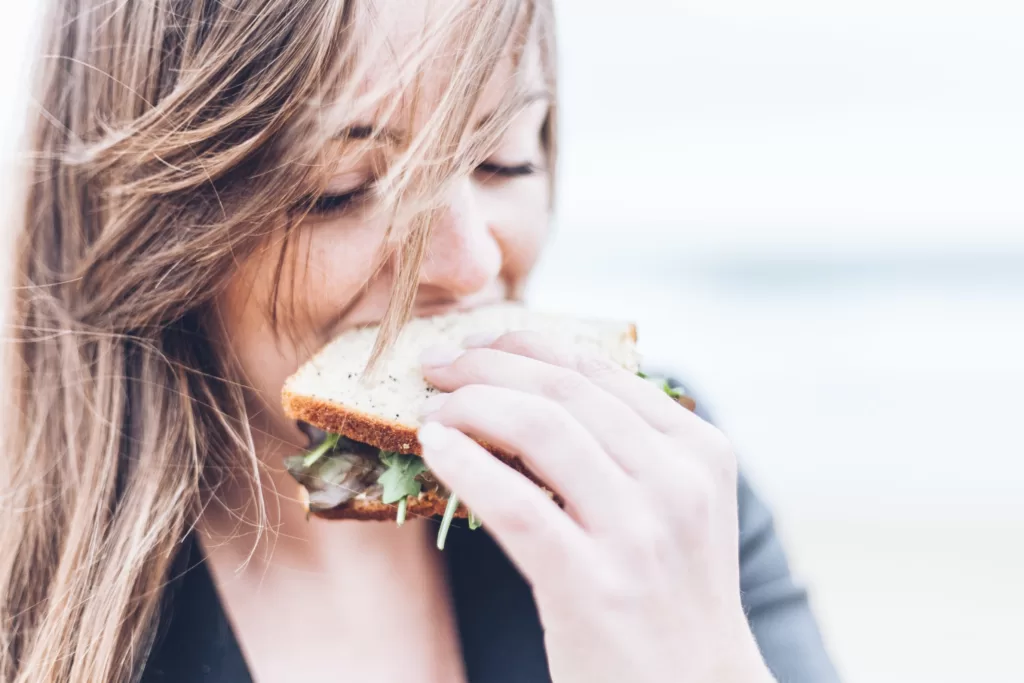 woman eating a healthy sandwich