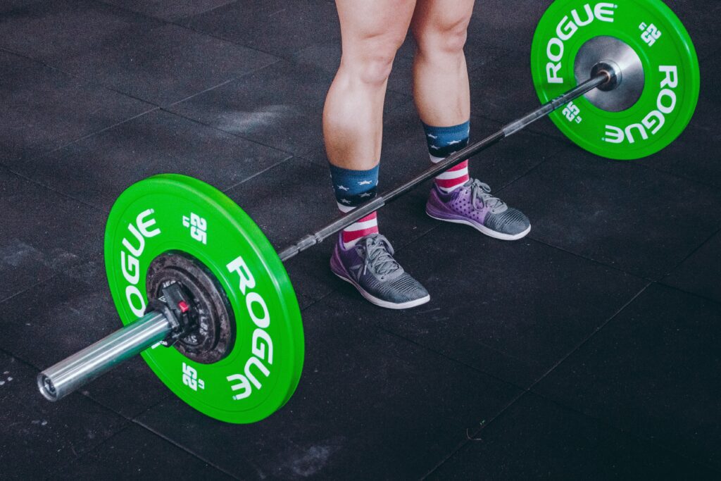 female athlete in grey crossfit shoes about to lift